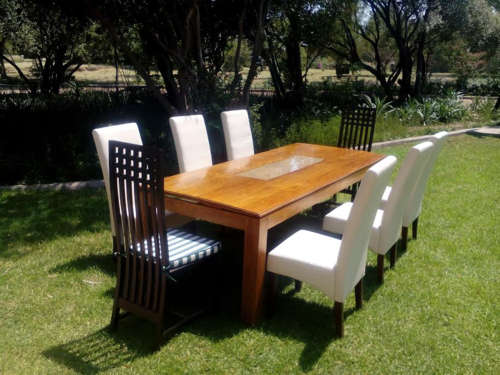 Solid wooden table with glass insert, together with 8 new dining Chairs