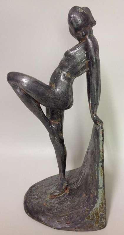 Art Deco Metal Figure of a Nude Lady with one leg pulled up and looking sideways - 23cm tall
