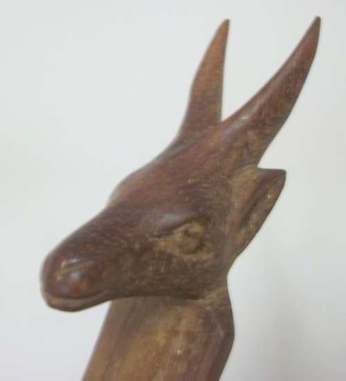 Beautifully Carved Stand with Buck Heads, supporting wooden bowl