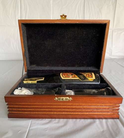 A BEAUTIFUL LINED WOODEN BOX WITH (HONEY LIQUEUR)