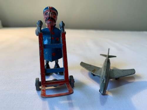 VINTAGE DINKY PLANE AND A MAN WITH A TROLLY.