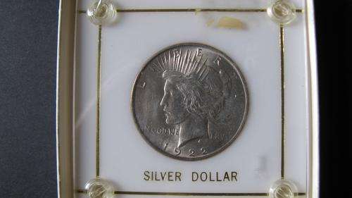 VERY SCARCE 1922 SILVER DOLLAR (PEACE) BRILLIANT UNC. IN SEALED HOLDER.