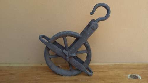 Large old metal pulley.