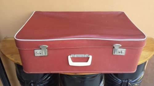 Large red soft top suitcase.