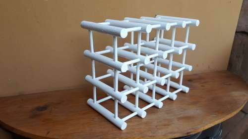 Old white wooden wine bottle holder.