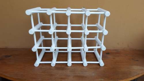 Old white wooden wine bottle holder.