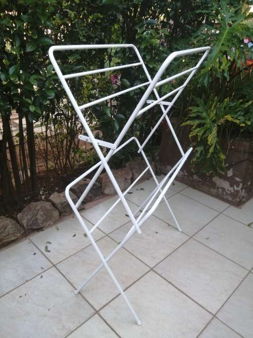 Old metal fold up clothes dryer.