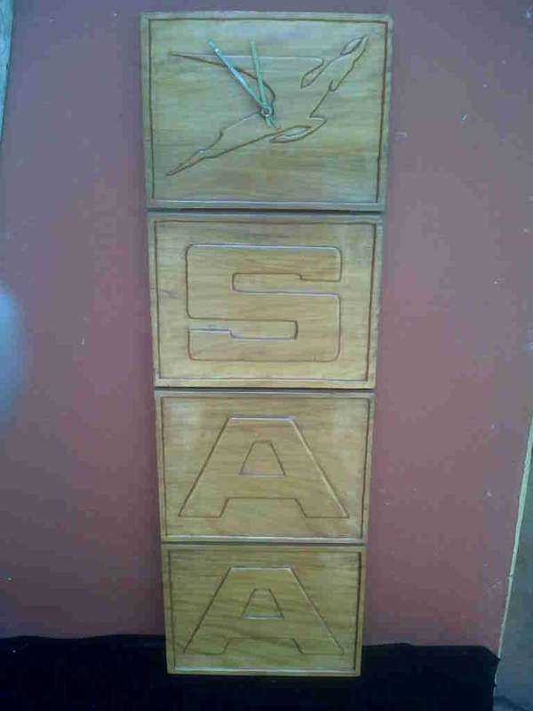 CARVED SAA WALL MOUNTED CLOCK