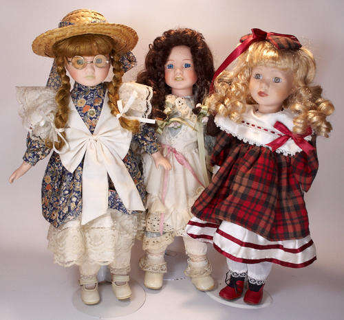 Three beautiful porcelain dolls on stands - stand approximately 430mm tall
