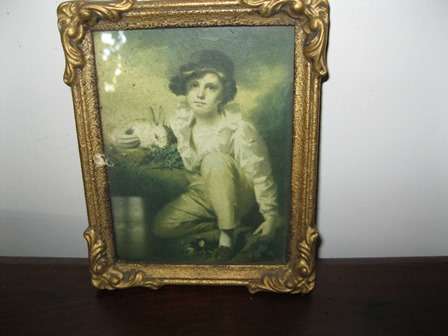 Print of a boy with a rabbit in a gold frame