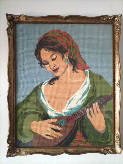 Framed Tapestry of Girl playing an Instrument.
