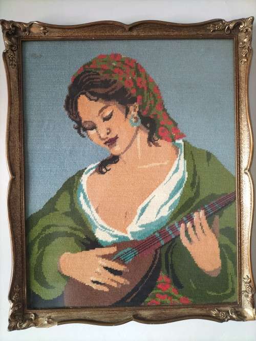 Framed Tapestry of Girl playing an Instrument.