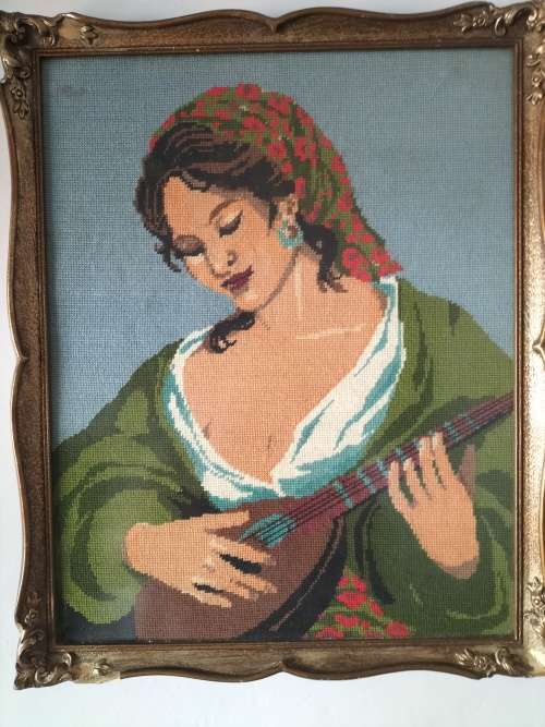 Framed Tapestry of Girl playing an Instrument.