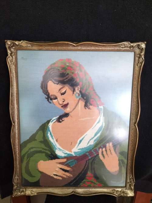 Framed Tapestry of Girl playing an Instrument.