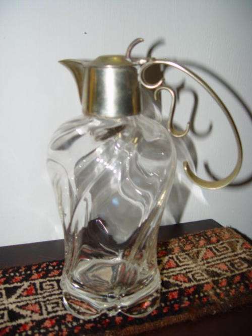 Glass wine decanter with silver top