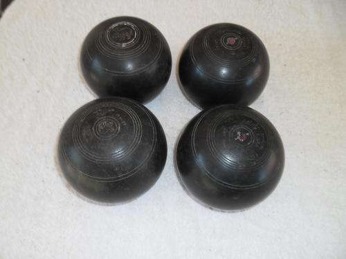 Four used 4 15/16 Standard Bowling Bolls