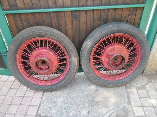 Two very old spoke steel wheels with very scares general tractor tires