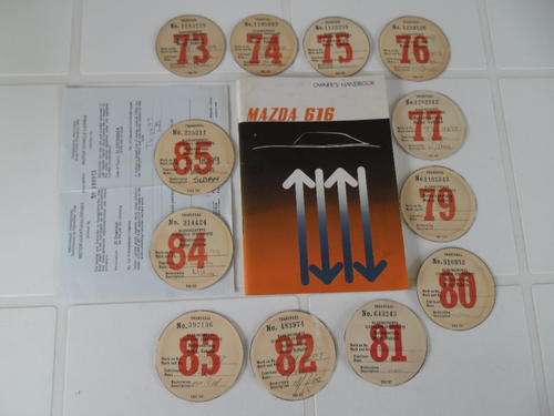 12 vintage motor vehicle licenses disc and owners handbook for Mazda sedan TV11699