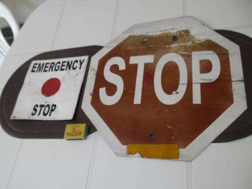 two well used metal stop signs small and medium