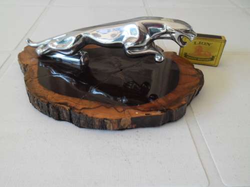 Old large Jaguar car mascot mounted on wood plinth postage is R60