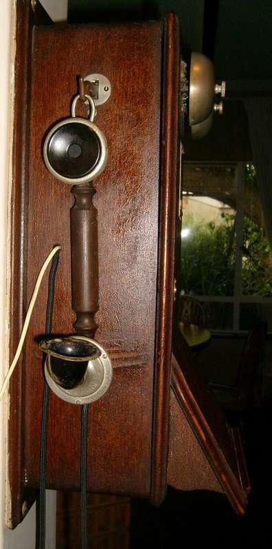 Genuine vintage crank-style wooden wall-mounted telephone.