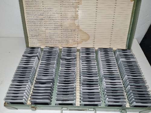 Lots of vintage slides in metal container