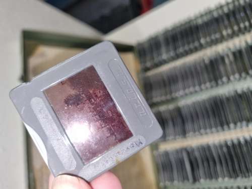 Lots of vintage slides in metal container