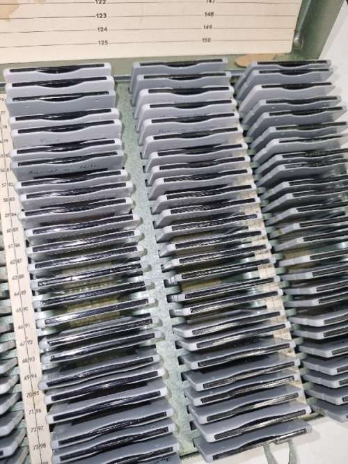 Lots of vintage slides in metal container