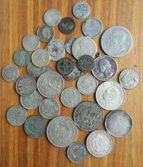 Collection of 35 silver coins from around the world. 122.69 grams.