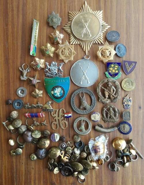 Large collection of vintage badges, pins and military buttons.