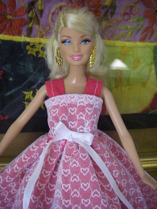 bright pink barbie doll dress with white lace overlay