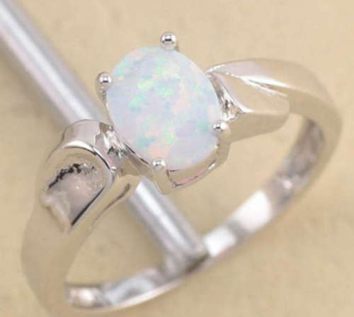 White gold filled ring with white fashion opal stone which reflects the light