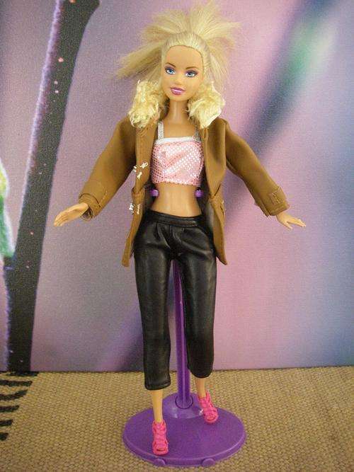 Black faux leather pants, pink top and brown faux leather winter jacket