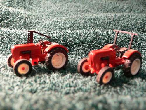 Set of 2 HO scale Porsche Tractors. Unboxed.