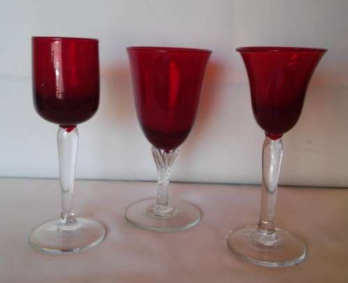 Three Red wine glasses with clear stems