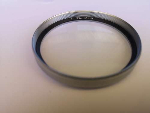 B+W vintage 72mm protective filter. Clear no extra stops (#1). Thick and heavy rim.