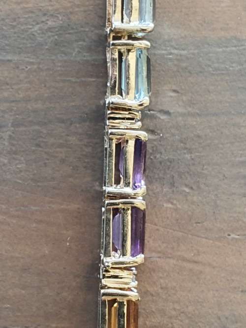 14k tennis bracelet set with various stones and diamond accents