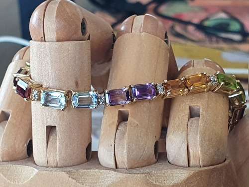 14k tennis bracelet set with various stones and diamond accents