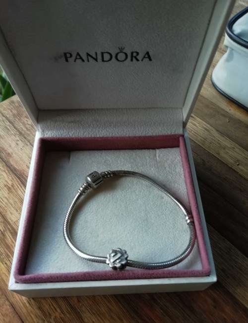 PANDORA SILVER BRACELET WITH SILVER CHARM.