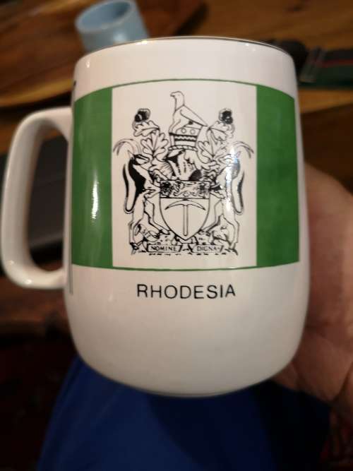 RHODESIAN REGIMENT STABLE BELT. TWO BEER MUGS.