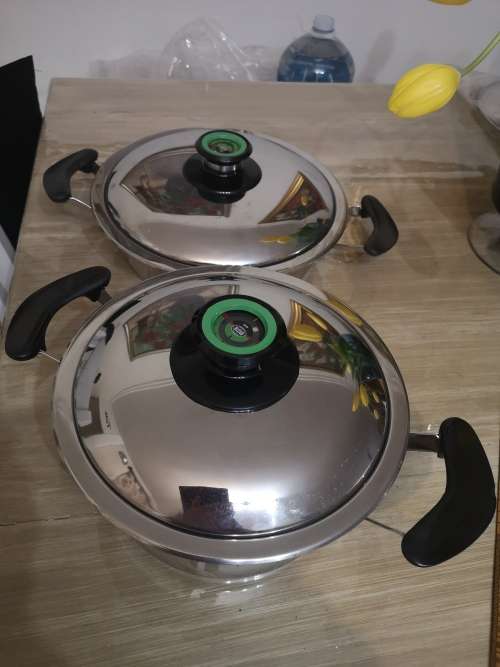 TWO AMC POTS. 20CM HIGH AND 24CM LOW.