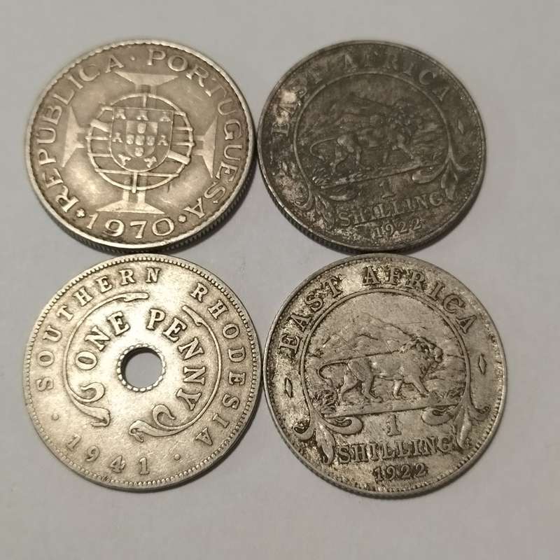 FOUR COINS, EAST AFRICA, 1922 ONE SHILLING, AND MACAMBIQUE AND SOUTH RHODESIA.