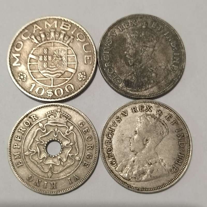 FOUR COINS, EAST AFRICA, 1922 ONE SHILLING, AND MACAMBIQUE AND SOUTH RHODESIA.
