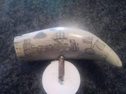 Unique Whale tooth inscribed with pictures depicting whaling activities and a ship.