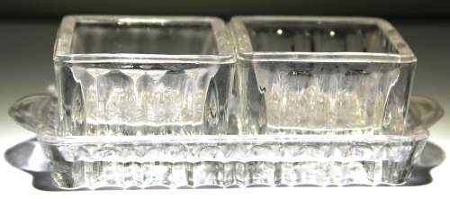 Small glass containers for salt and pepper