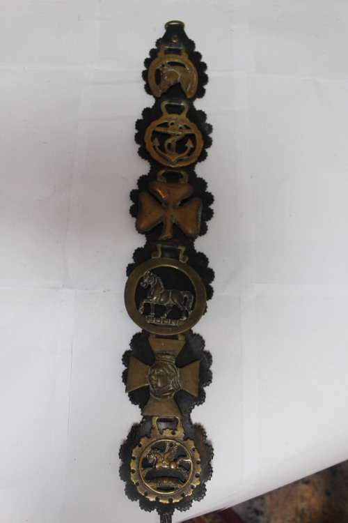 Horse medallions hung on leather