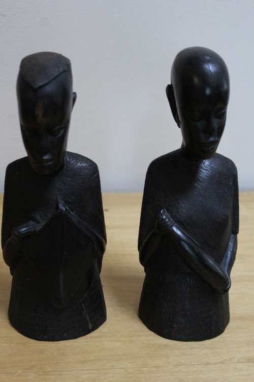A pair of small African carved wooden figures