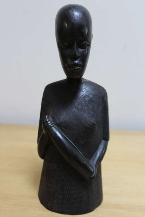 A pair of small African carved wooden figures
