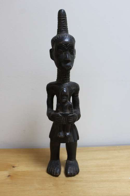 Central African carved wooden figure of a mother holding her baby