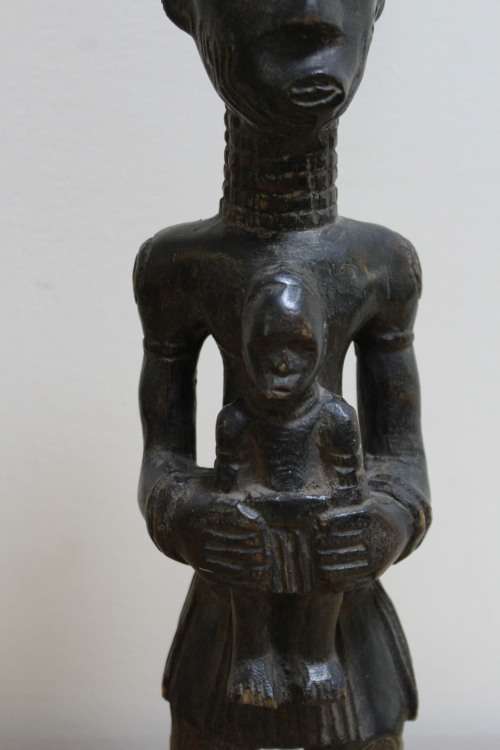 Central African carved wooden figure of a mother holding her baby